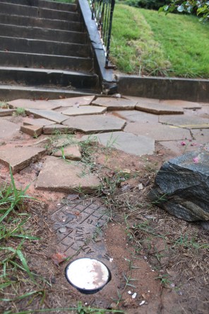 Water meter and torn-up sidewalk after service line repair