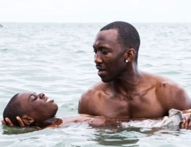 Man teaching boy to swim